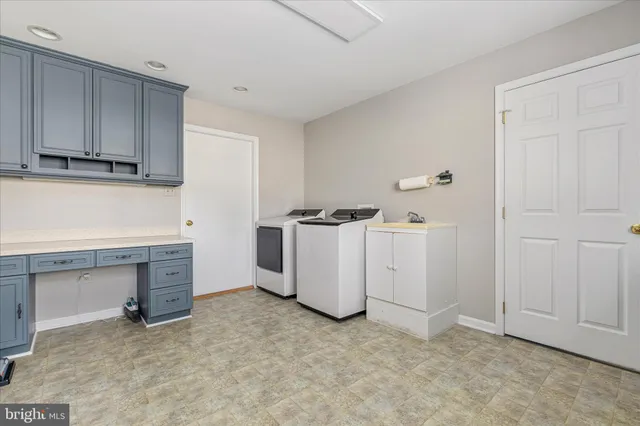 a view of a swimming pool and lounge chairs in the patio