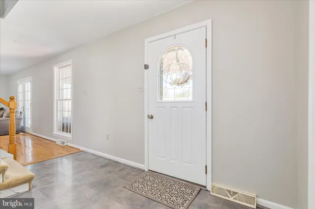 a bedroom with a bed and a dresser next to a window