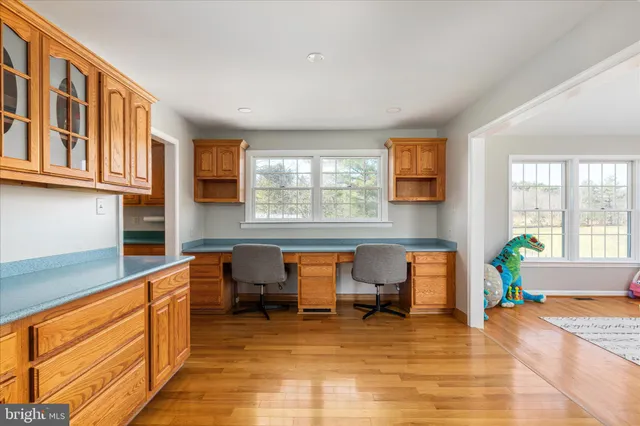 a kitchen with cabinets appliances and a window