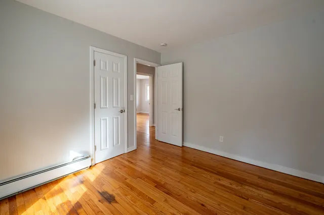 a view of an empty room and wooden floor