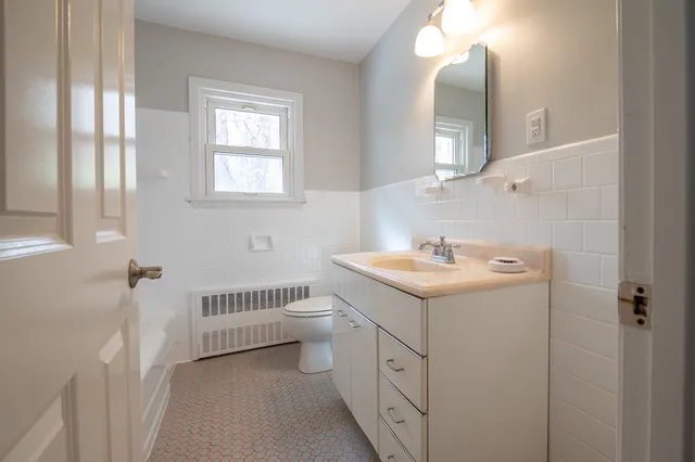 a bathroom with a sink toilet and a mirror