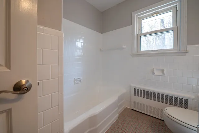 a bathroom with a tub and a window
