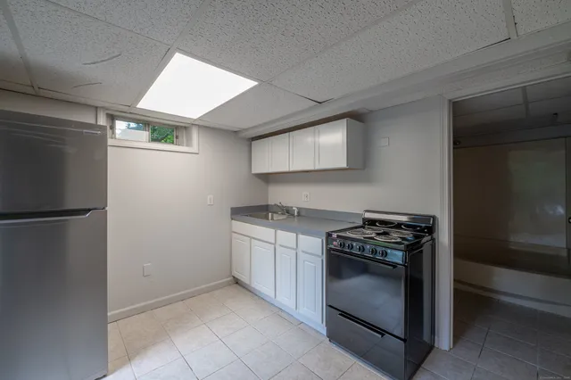 a kitchen with stainless steel appliances granite countertop a refrigerator and a stove