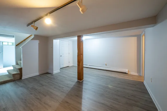 wooden floor in an empty room with a window