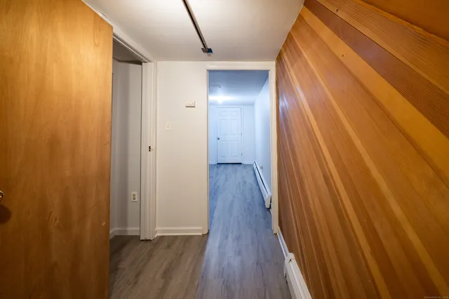 a view of a hallway with wooden floor