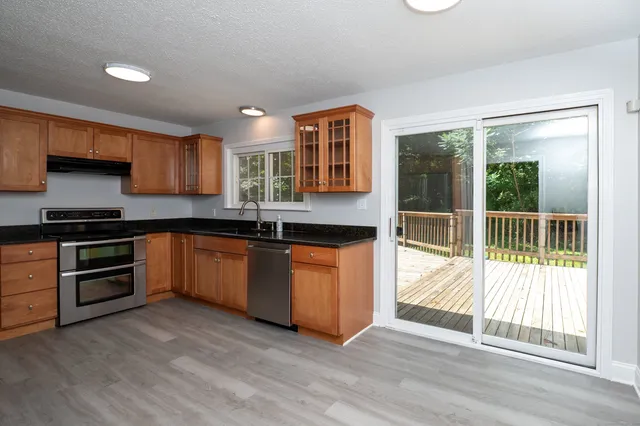 a kitchen with granite countertop a stove a sink and a granite counter top