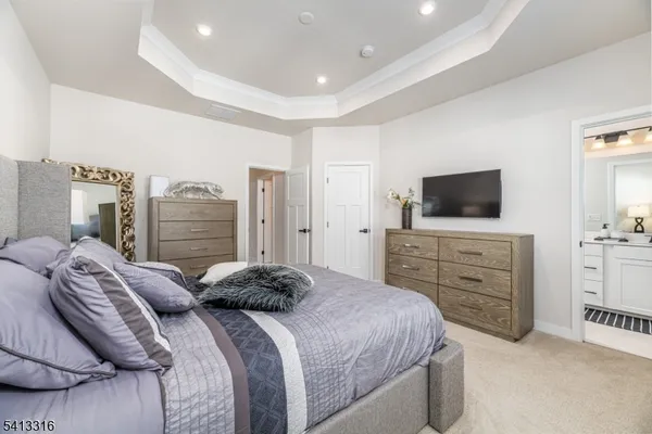 a bedroom with a bed and flat screen tv