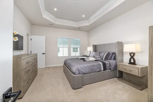 a bedroom with bed cabinet and window