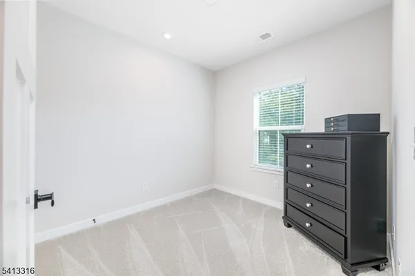 a room with a dresser and a window