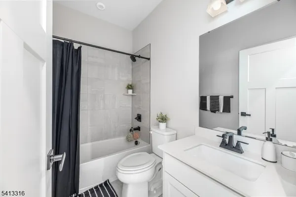 a bathroom with a sink toilet tub and shower