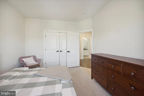 a bedroom with a bed and a dresser
