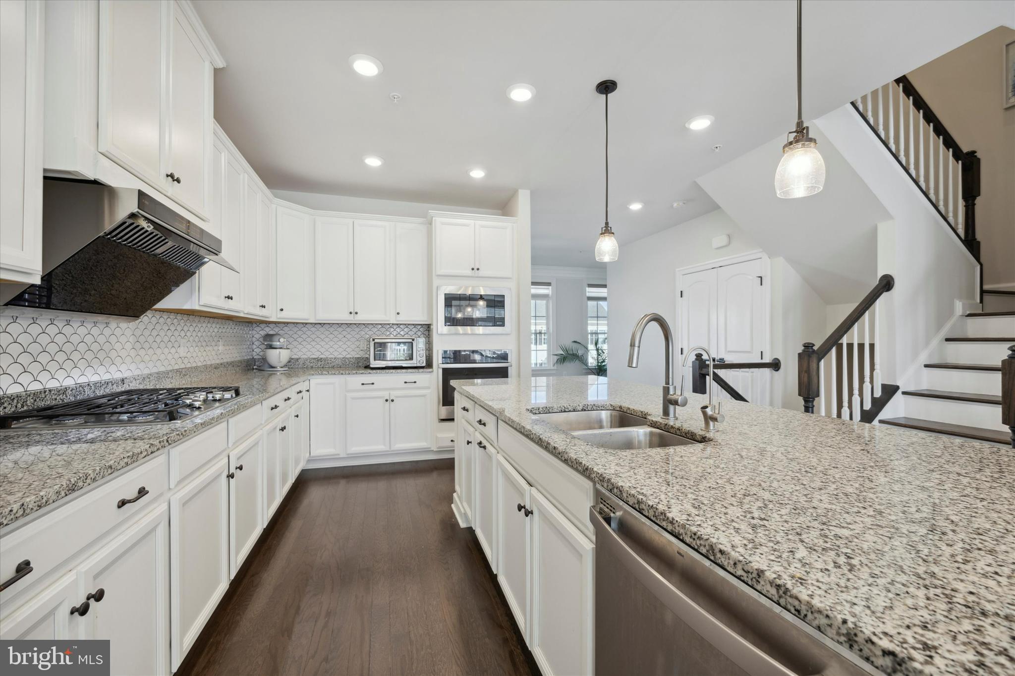 831 Stonecliffe Road Malvern, PA 19355 - Photo 5 of 32 a large kitchen with granite countertop a sink a counter top space stainless steel appliances and cabinets
