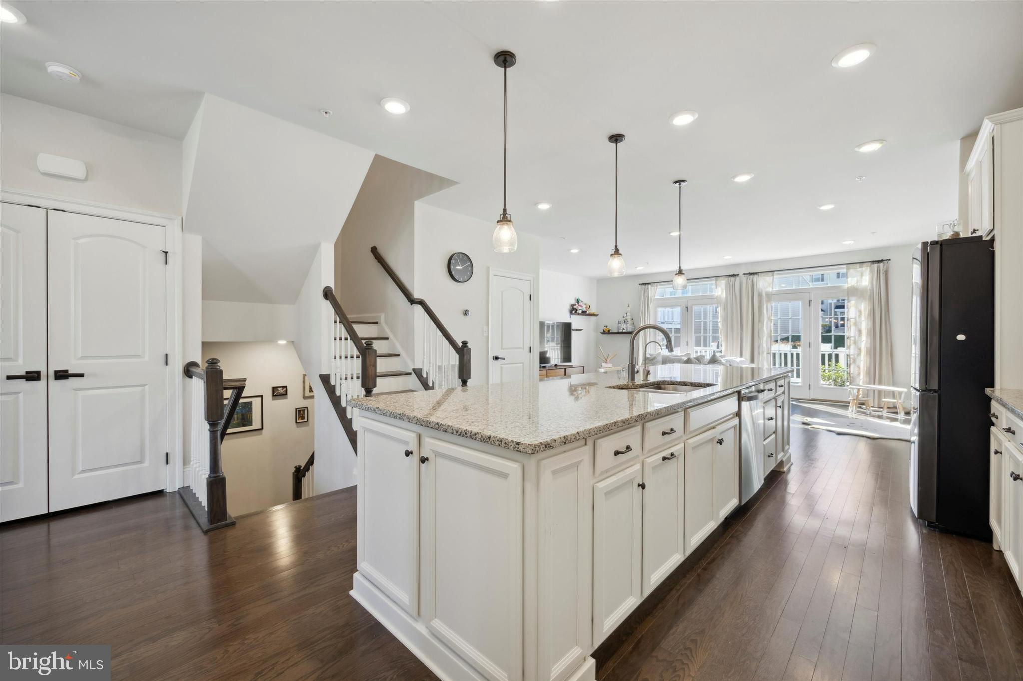 831 Stonecliffe Road Malvern, PA 19355 - Photo 6 of 32 a large kitchen with stainless steel appliances kitchen island granite countertop a large island a stove a sink a refrigerator and a wooden floor