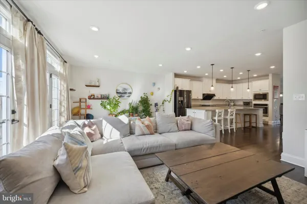 a living room with furniture and kitchen view
