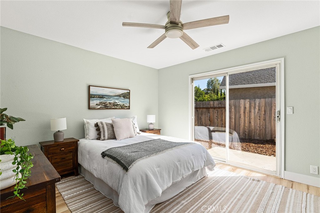 1572 Arch Way Chico, CA 95973 - Photo 13 of 43 a bedroom with a large bed and a chandelier