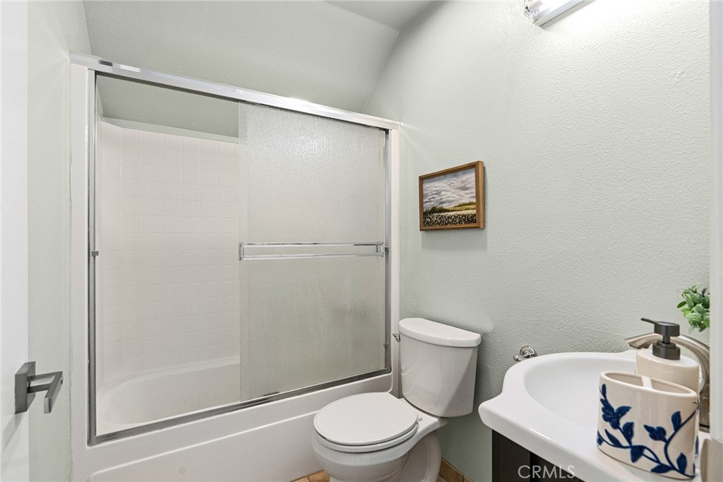 1572 Arch Way Chico, CA 95973 - Photo 26 of 43 a white toilet sitting next to a bathroom sink