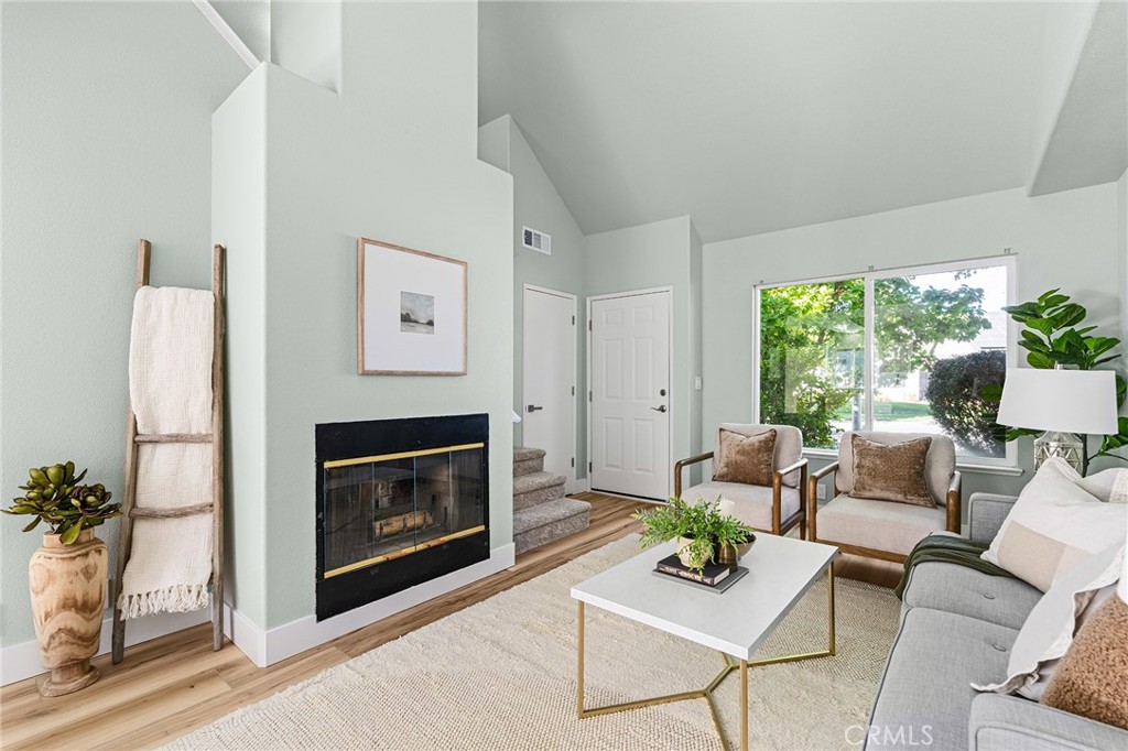 1572 Arch Way Chico, CA 95973 - Photo 5 of 43 a living room with furniture a fireplace and a potted plant