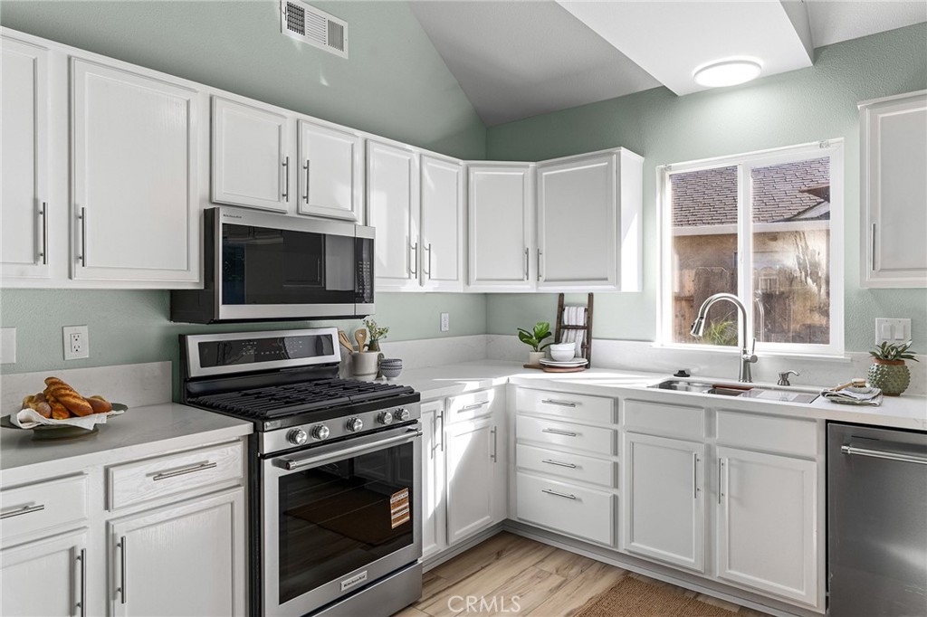 1572 Arch Way Chico, CA 95973 - Photo 8 of 43 a kitchen with cabinets appliances a sink and a window