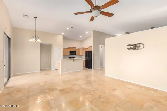 a view of a kitchen with a sink and a refrigerator