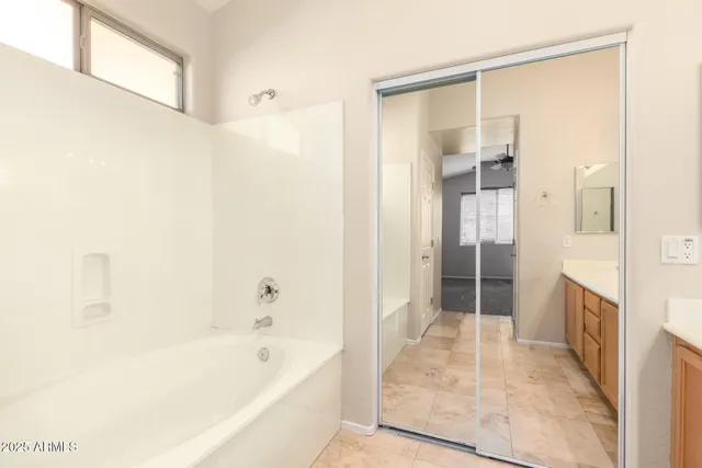 a bathroom with a bathtub and a shower