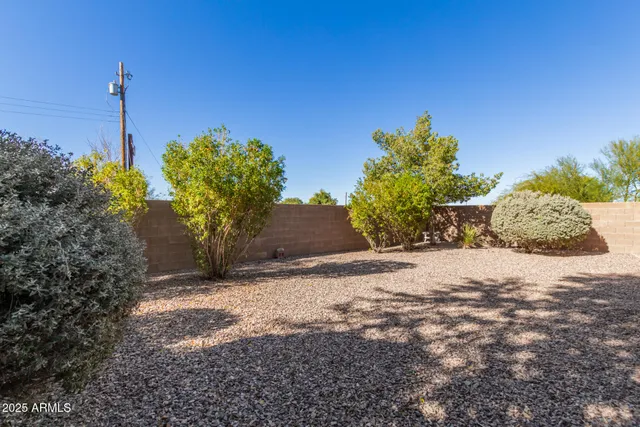 a view of a wooden fence next to a road