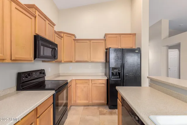 a kitchen with stainless steel appliances granite countertop a refrigerator stove top oven and sink