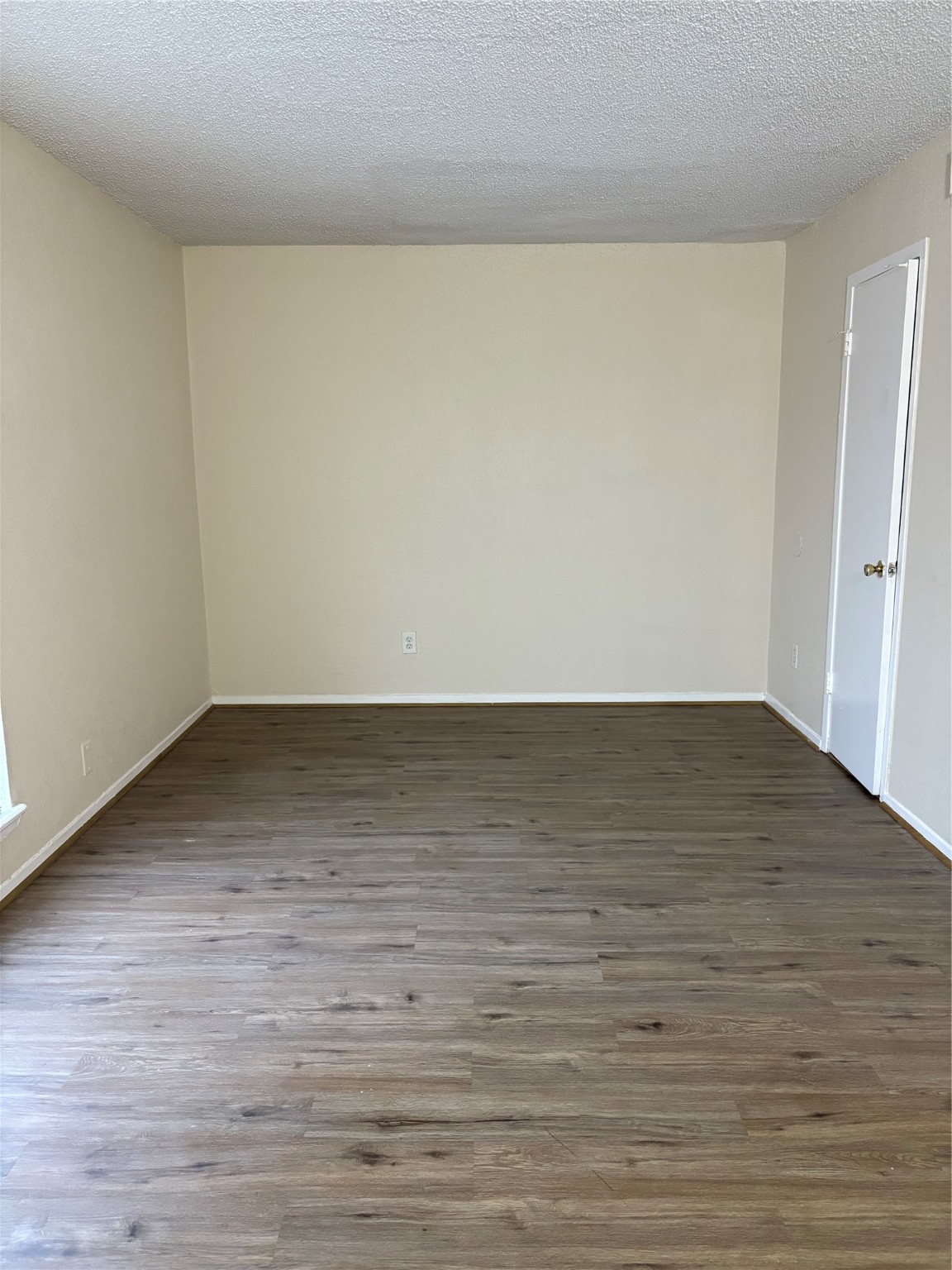 101 East Hospital Drive, Unit 10 Angleton, TX 77515 - Photo 14 of 14 a view of an empty room with wooden floor