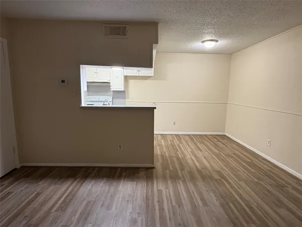 a view of a room with wooden floor