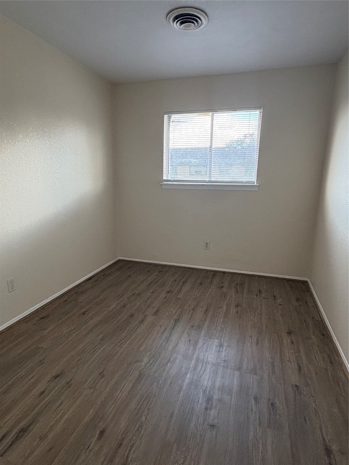 101 East Hospital Drive, Unit 10 Angleton, TX 77515 - Photo 7 of 14 an empty room with wooden floor and windows