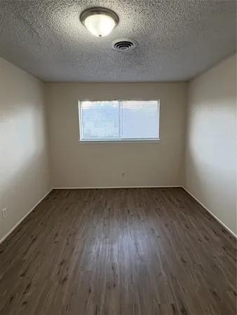 a view of a room with wooden floor and white walls