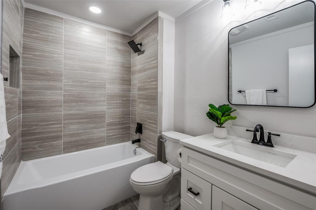 6000 Blue Ridge Trail Plano, TX 75023 - Photo 14 of 25 Bathroom featuring shower combination, vanity, and a textured wall