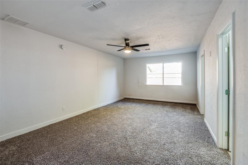 6000 Blue Ridge Trail Plano, TX 75023 - Photo 19 of 25 Unfurnished room with carpet floors, a ceiling fan, and a textured ceiling