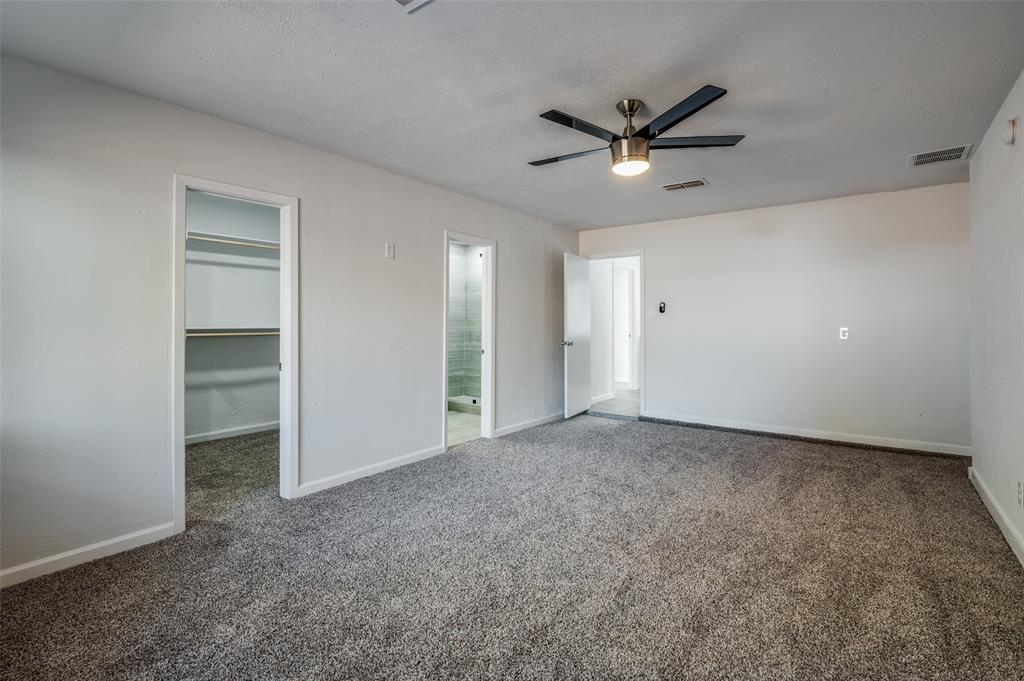 6000 Blue Ridge Trail Plano, TX 75023 - Photo 20 of 25 Unfurnished bedroom with a spacious closet, dark colored carpet, ceiling fan, and ensuite bath
