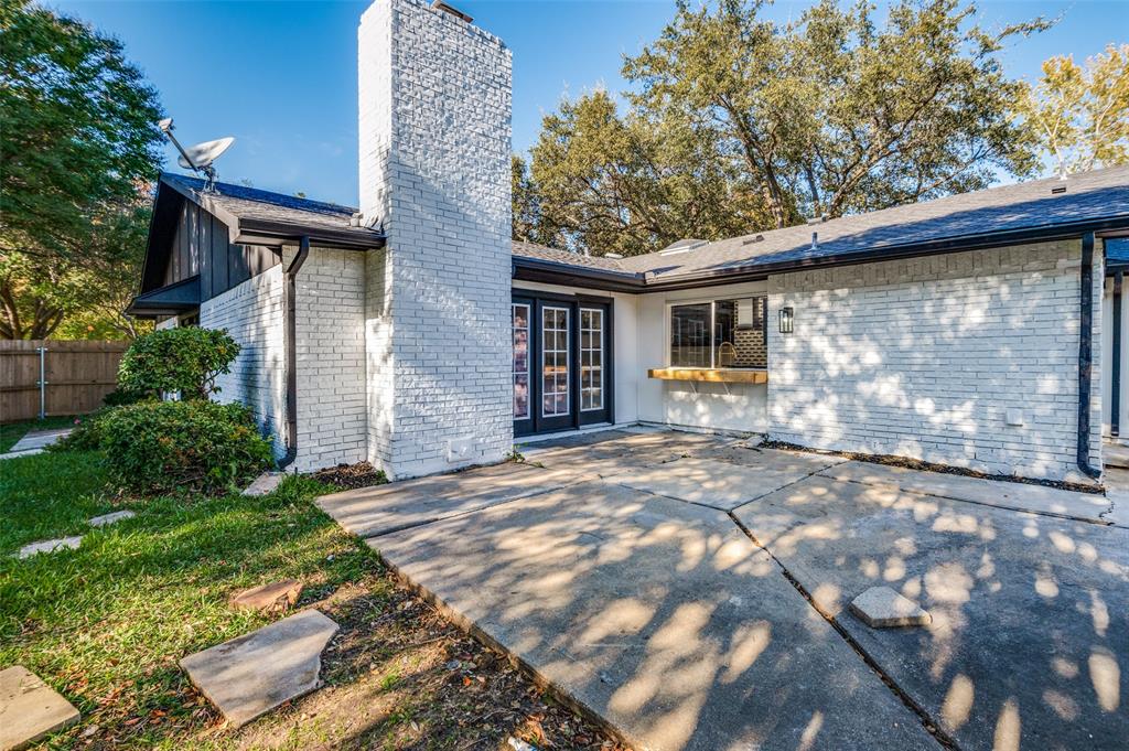 6000 Blue Ridge Trail Plano, TX 75023 - Photo 23 of 25 Rear view of house featuring a chimney, brick siding, a patio area, and french doors