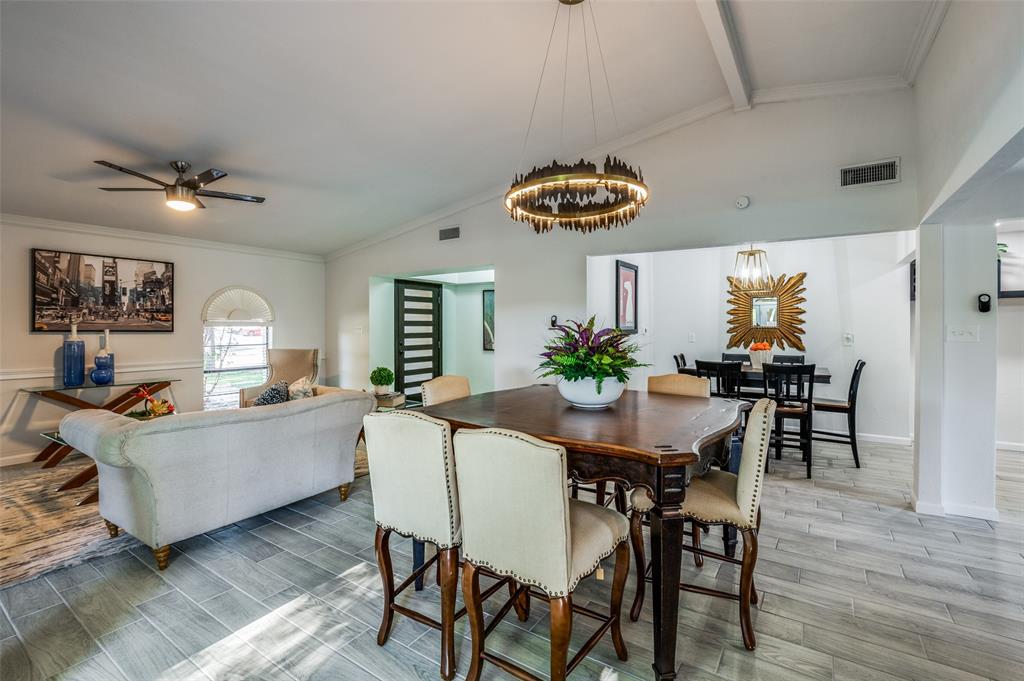 6000 Blue Ridge Trail Plano, TX 75023 - Photo 7 of 25 Dining room with crown molding, light wood finished floors, a chandelier, and ceiling fan