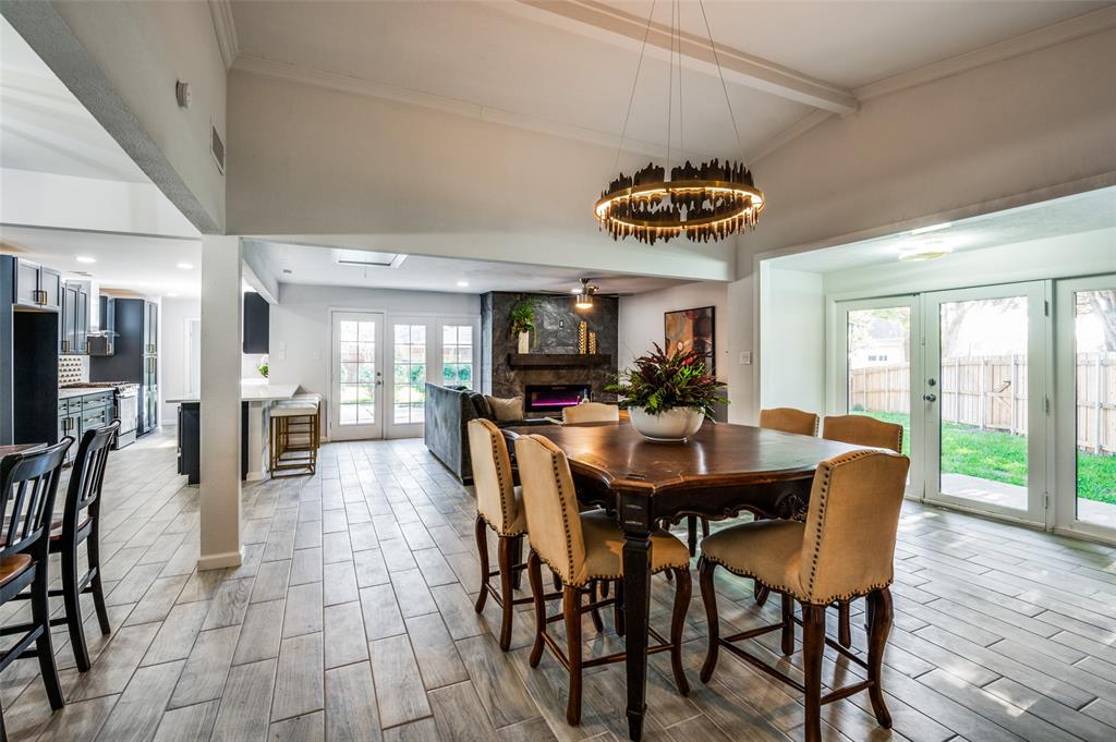 6000 Blue Ridge Trail Plano, TX 75023 - Photo 8 of 25 Dining area featuring french doors, a fireplace, wood tiled floors, and a ceiling fan