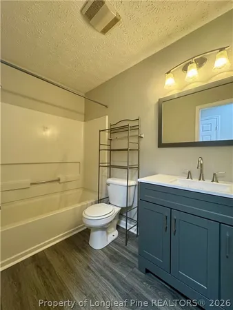 a bathroom with a toilet a sink and shower