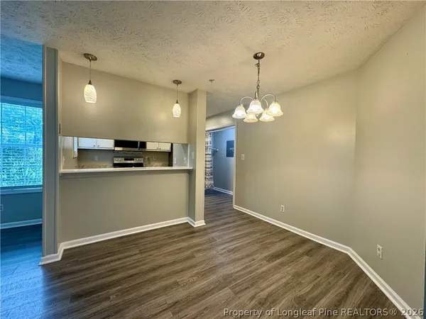 a view of a kitchen with a dishwasher cabinets and wooden floor