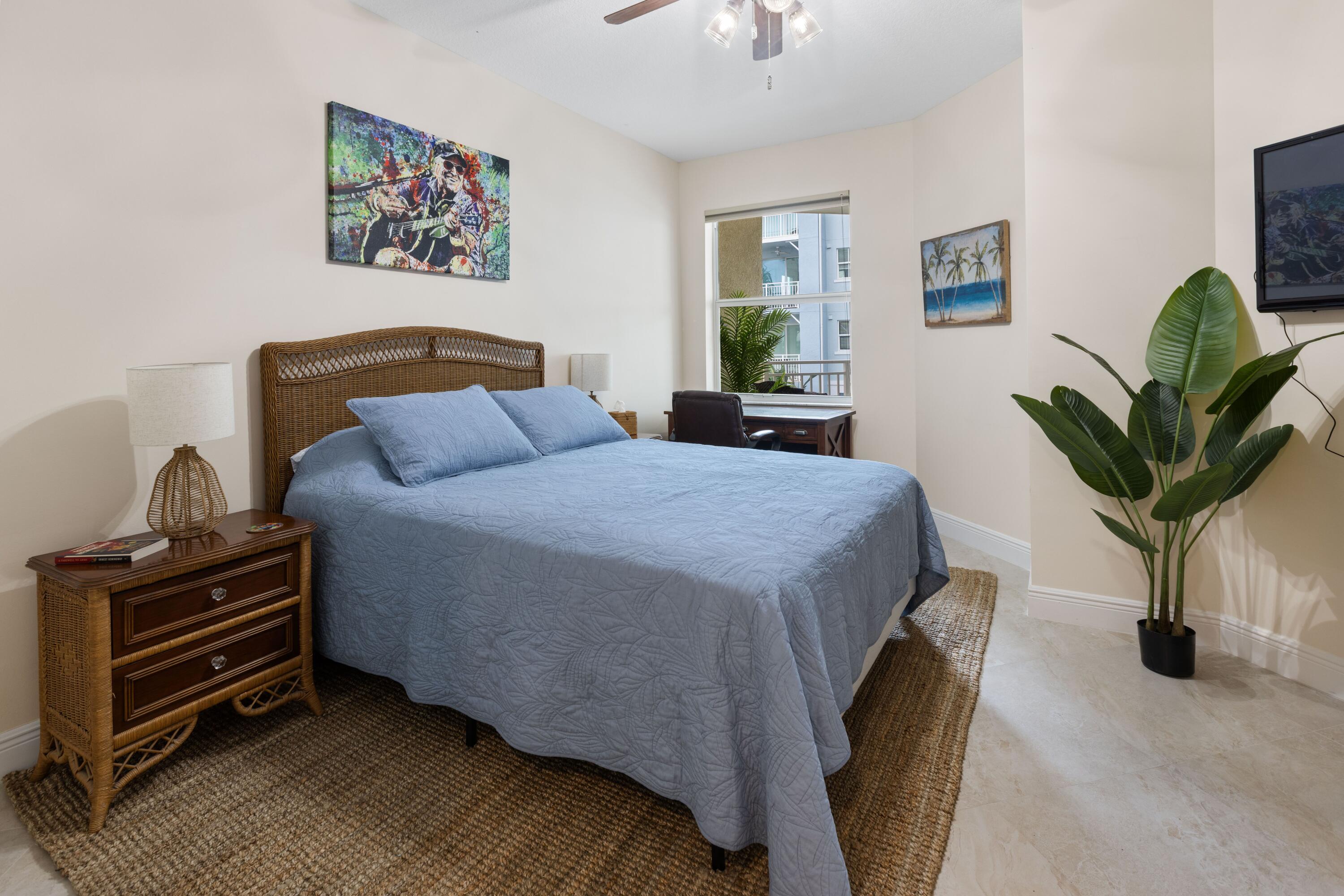 275 Northwest Flagler Avenue, Unit 205 Stuart, FL 34994 - Photo 17 of 43 a bedroom with a bed and a potted plant