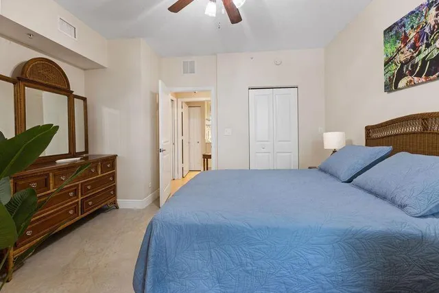 a bedroom with a bed and a dresser next to a window