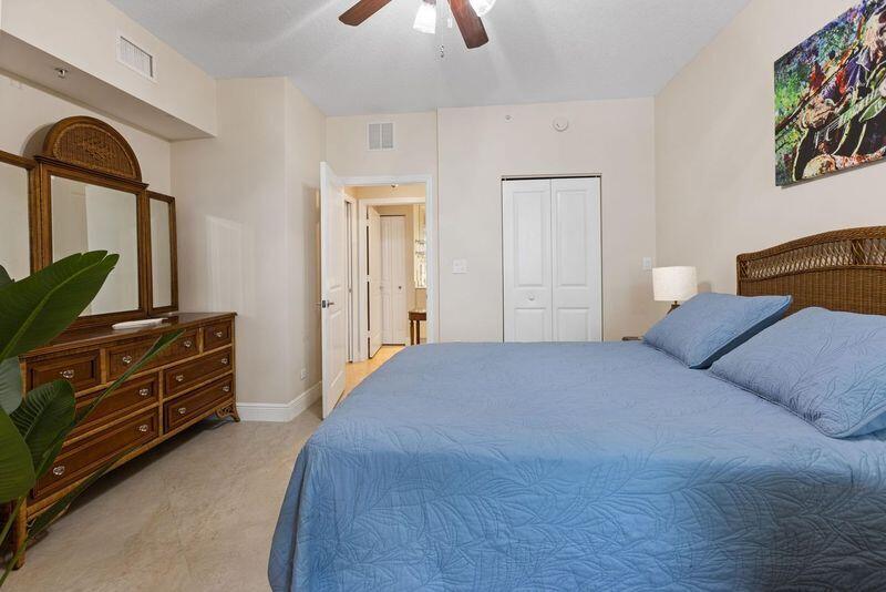 275 Northwest Flagler Avenue, Unit 205 Stuart, FL 34994 - Photo 18 of 43 a bedroom with a bed and a dresser