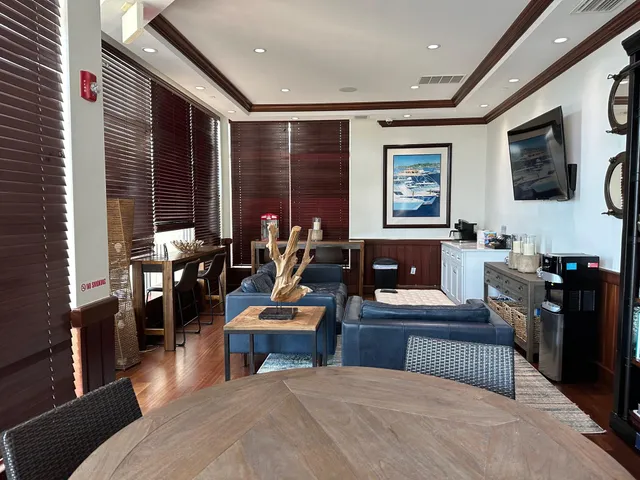 a dining room with wooden floor glass table and chairs