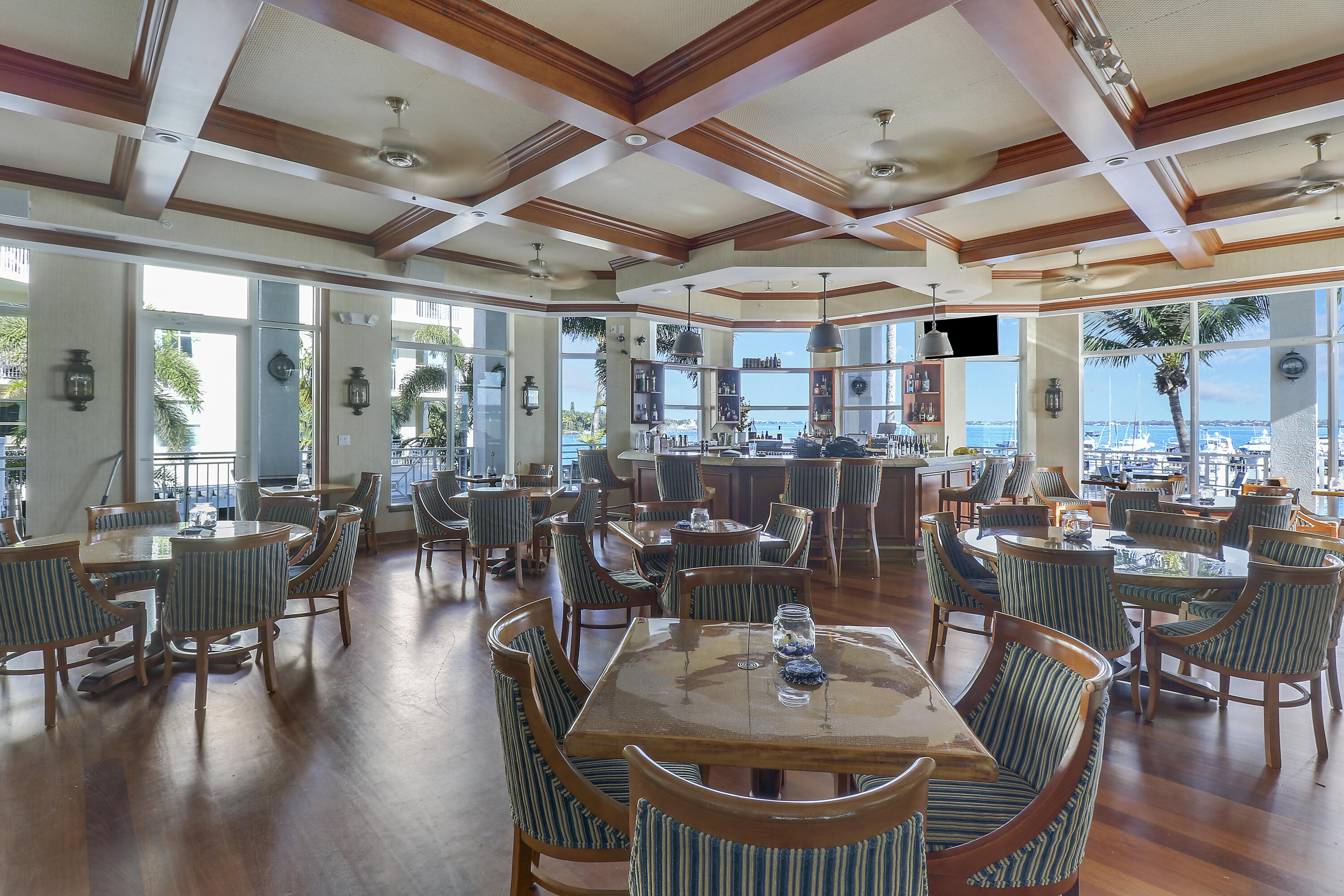 275 Northwest Flagler Avenue, Unit 205 Stuart, FL 34994 - Photo 36 of 43 a dining room with wooden floor glass table and chairs