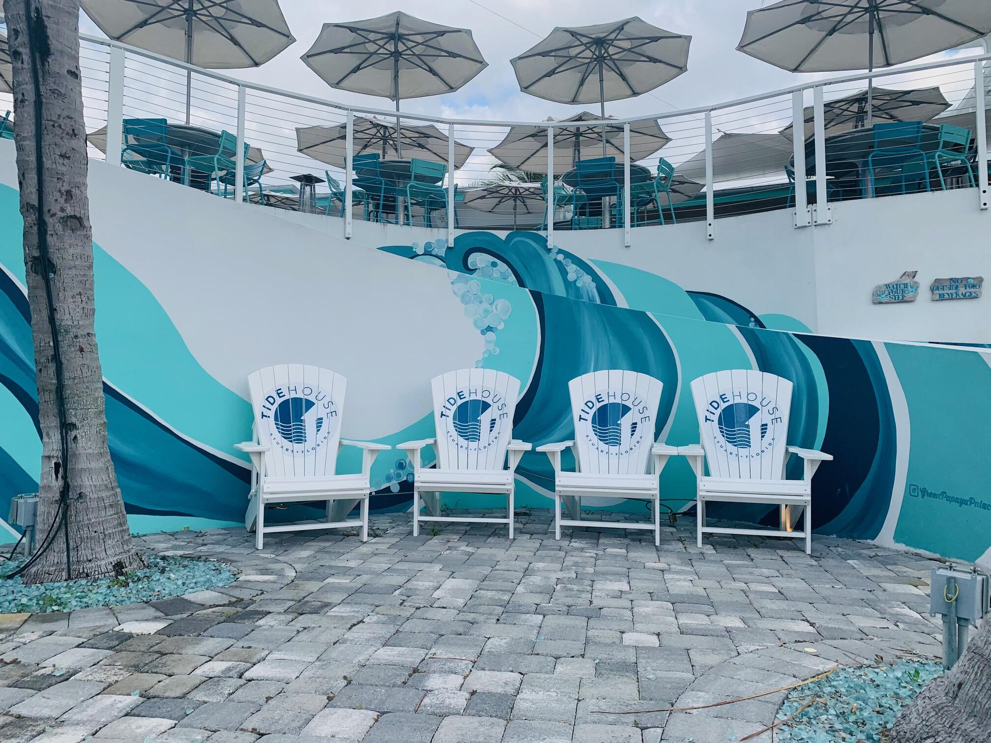 275 Northwest Flagler Avenue, Unit 205 Stuart, FL 34994 - Photo 39 of 43 a view of a chairs and table in backyard