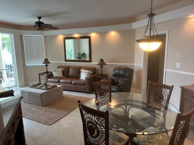 275 Northwest Flagler Avenue, Unit 205 Stuart, FL 34994 - Photo 5 of 43 a living room with furniture and a chandelier
