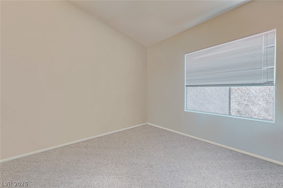 2305 West Horizon Ridge Parkway, Unit 1223 Henderson, NV 89052 - Photo 21 of 28 Spare room with carpet and vaulted ceiling