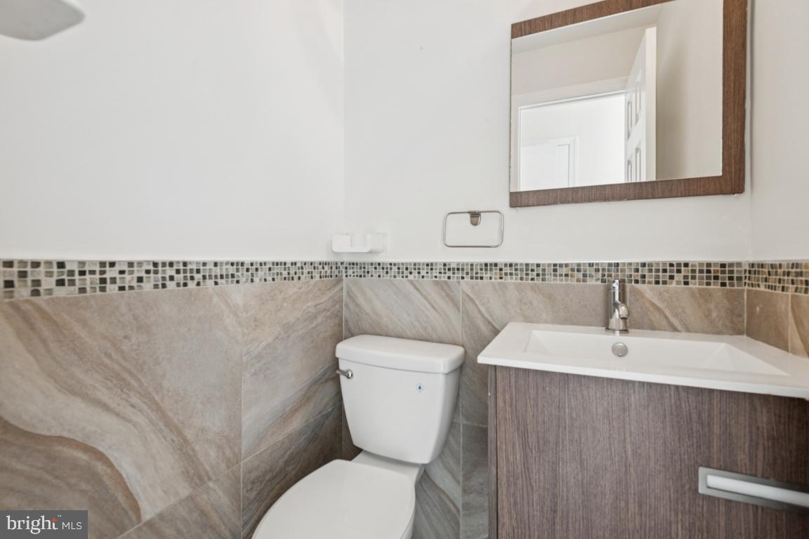 3240 Hewitt Avenue, Unit 63A Silver Spring, MD 20906 - Photo 12 of 22 a bathroom with a toilet a sink and mirror