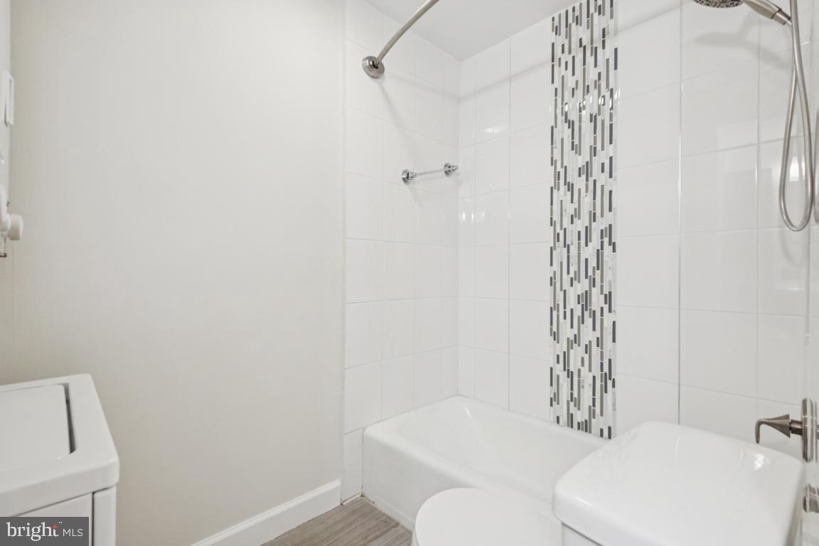3240 Hewitt Avenue, Unit 63A Silver Spring, MD 20906 - Photo 17 of 22 a white toilet and shower curtain
