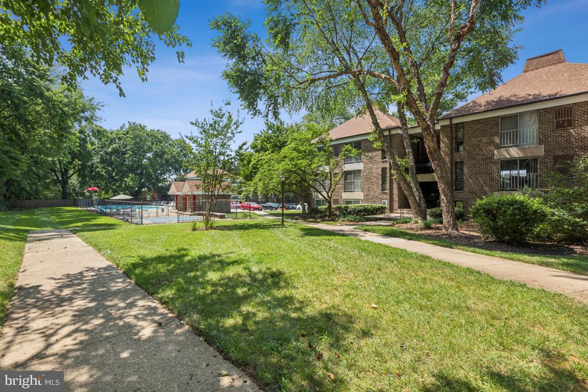 3240 Hewitt Avenue, Unit 63A Silver Spring, MD 20906 - Photo 21 of 22 a view of a house with garden and a tree