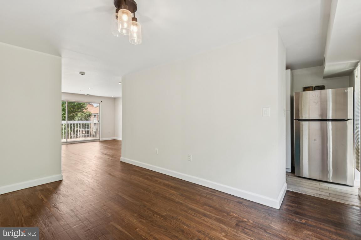 3240 Hewitt Avenue, Unit 63A Silver Spring, MD 20906 - Photo 7 of 22 an empty room with wooden floor and windows